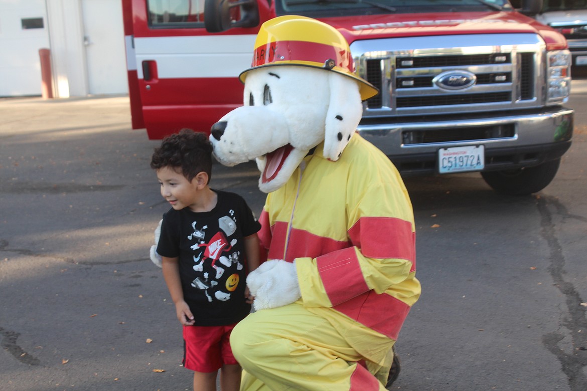 Adriel Zepeda gets his picture taken with Sparky the Fire Dog during the open house at Grant County Fire District 3 Oct. 11. The district is celebrating its 80th anniversary in 2022.