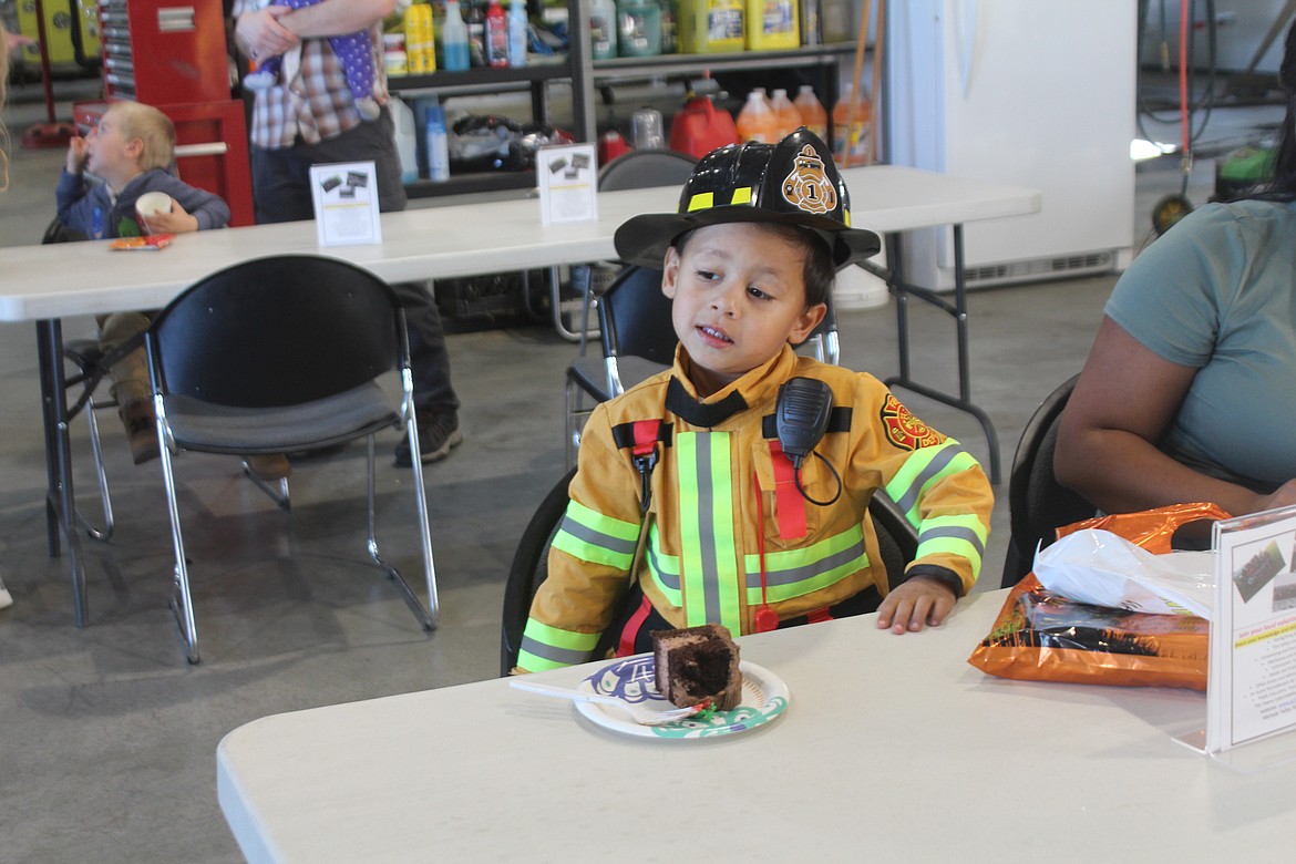 Camilo Tamiche wore his fire turnouts and radio, and got some of the cake, at the Oct. 11 open house sponsored by Grant County Fire District 3.