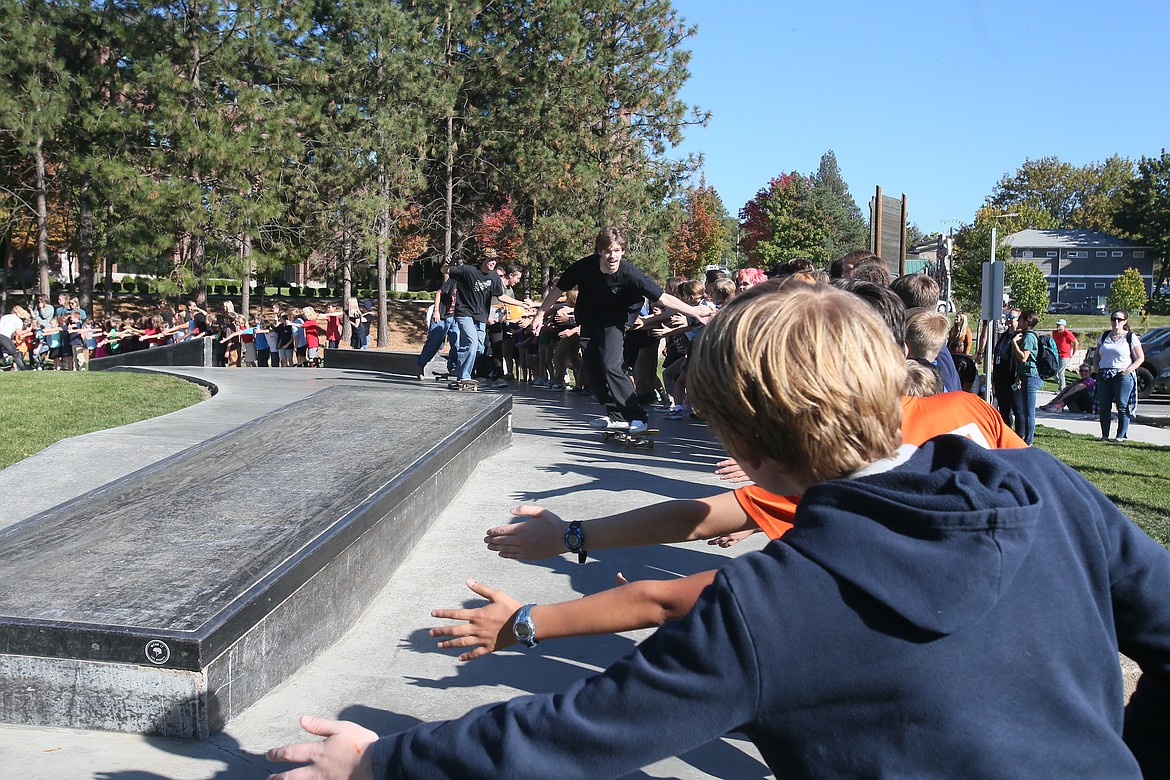 Skateboarder Rylan Beaton high-fives Sorensen students Thursday at the close of a demonstration in the Coeur d'Alene Skate Park. The students will welcome skateboard artist Mark Rivard on Monday.