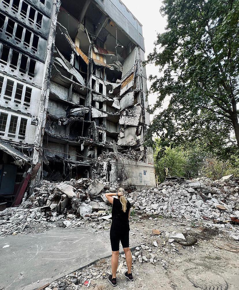 A friend of Vitalina Zinchenko surveys the damage to an apartment building, located not far from where the Zinchenko lived in Kharkiv in Ukraine. (photo provided)