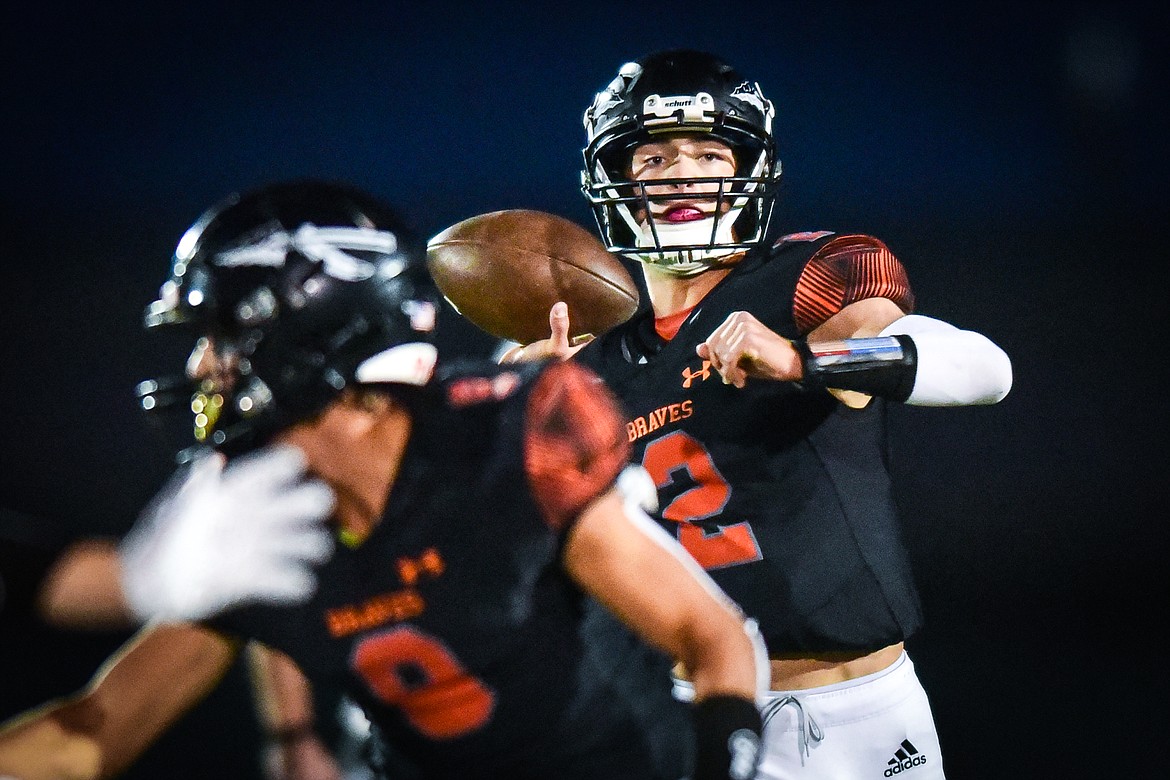 Flathead quarterback Jackson Walker (2) rolls out to pass in the first quarter against Glacier at Legends Stadium on Friday, Oct. 14. (Casey Kreider/Daily Inter Lake)