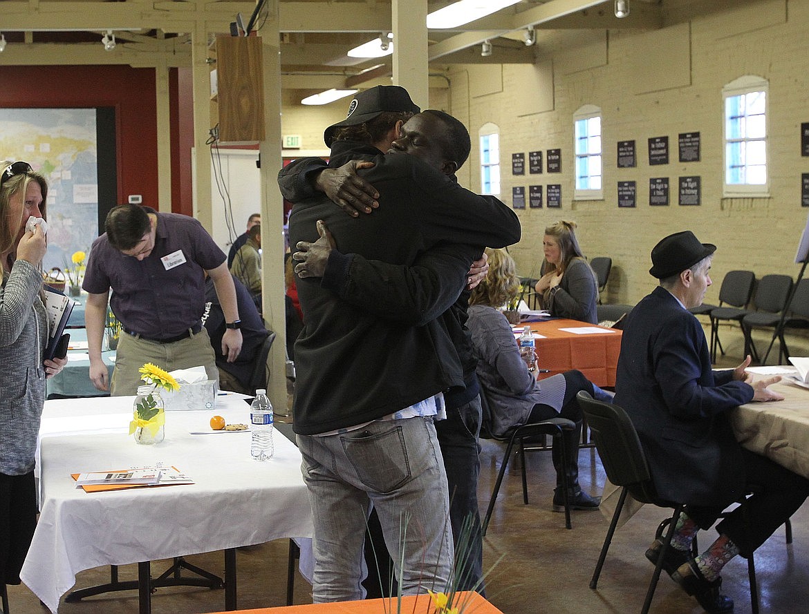 Elijah Price, left, shares a hug with Jackson Lino, a 29-year-old South Sudanese refugee during the 2018 Human Library event at the Human Rights Education Institute in Coeur d'Alene.