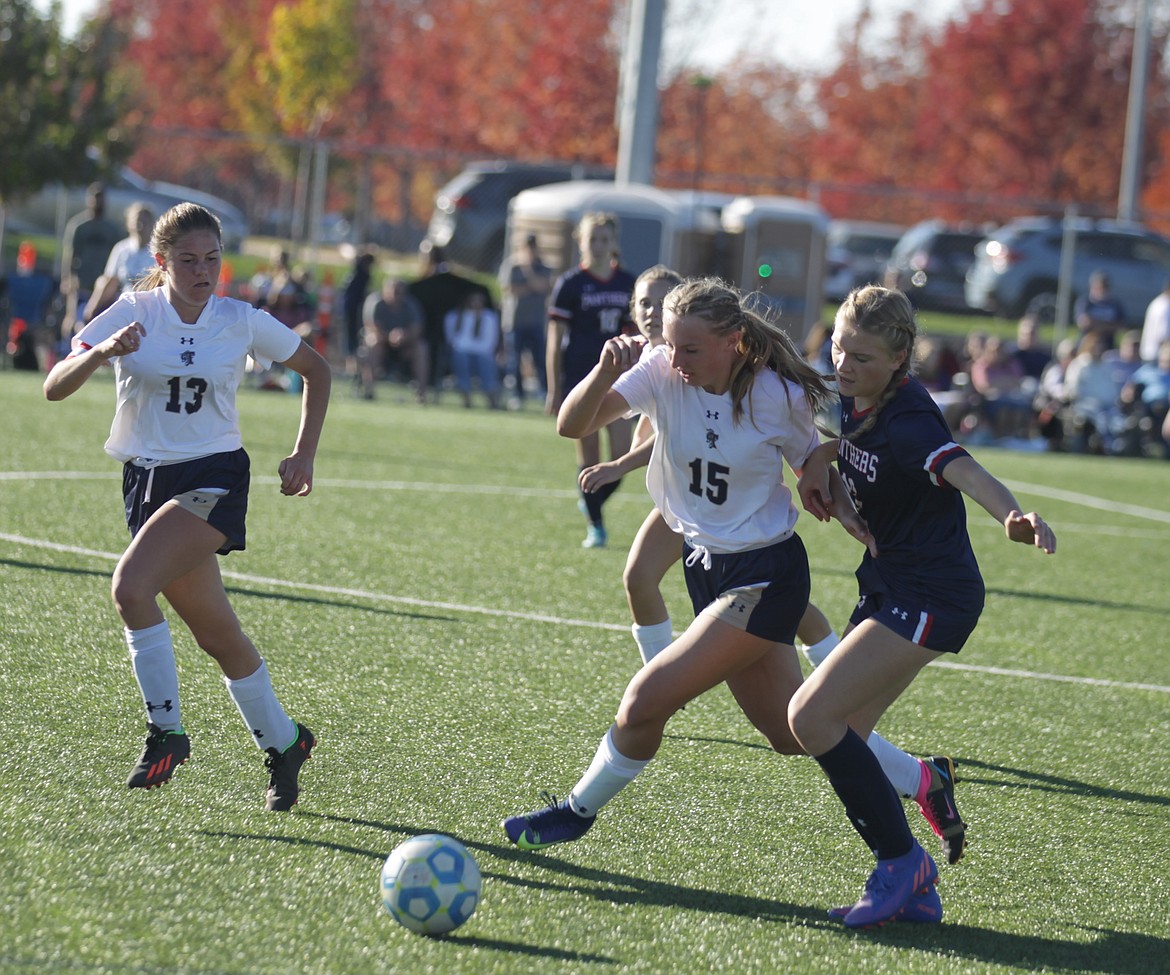 JASON ELLIOTT/Press
Timberlake freshman Payton Young (15) holds off Coeur d'Alene Charter's Abigail Johnson during the second half of Saturday's 3A District 1-2 girls soccer championship match at The Fields in Post Falls.