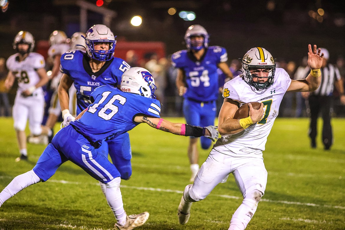 Senior Whitefish quarterback Fynn Ridgeway evades a tackle in Columbia Falls on Friday, Oct. 14. (JP Edge/Hungry Horse News)