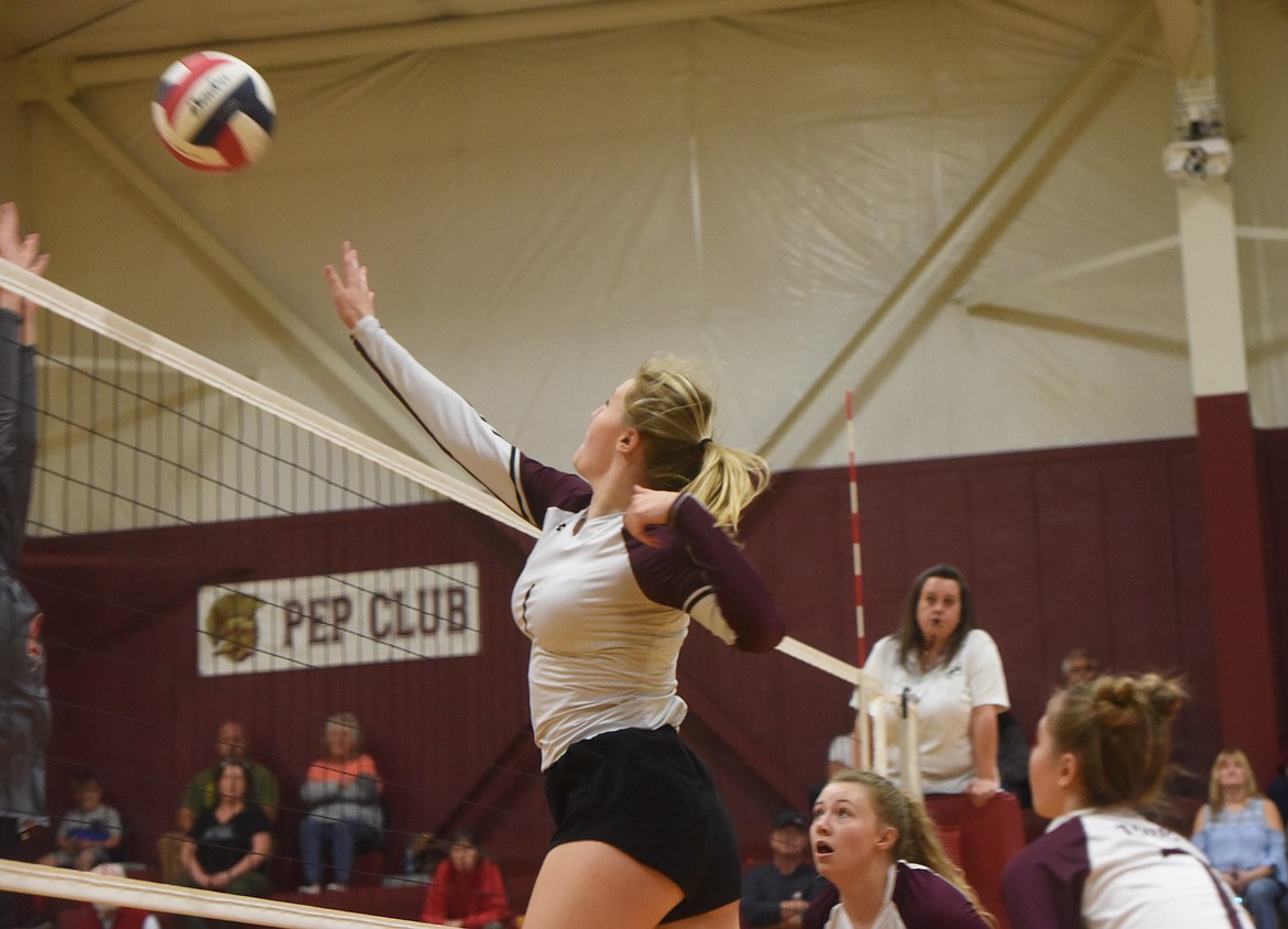 Troy volleyball player Autumn Fisher tips a shot over the net against Arlee on Saturday, Oct. 15. (Scott Shindledecker/The Western News)