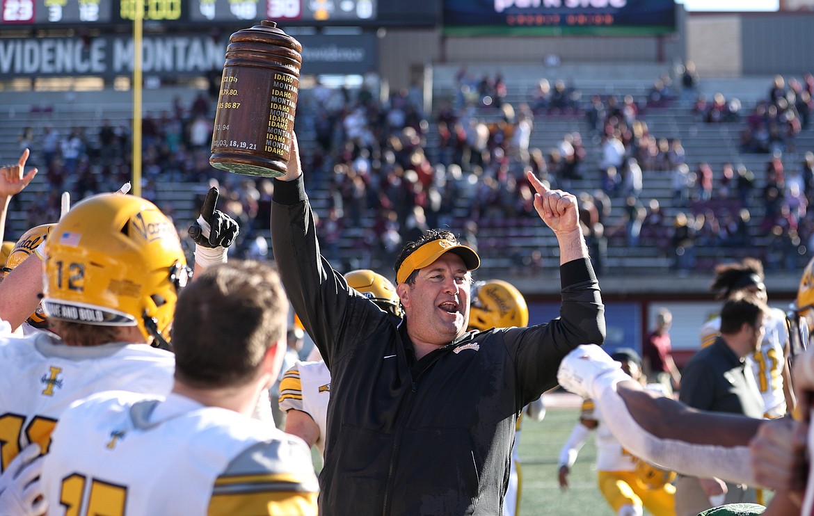 CODY ROBERTS/Idaho Athletics
First-year Idaho coach Jason Eck holds up the Little Brown Stein after the Vandals' 30-23 win over Montana on Saturday in Missoula.