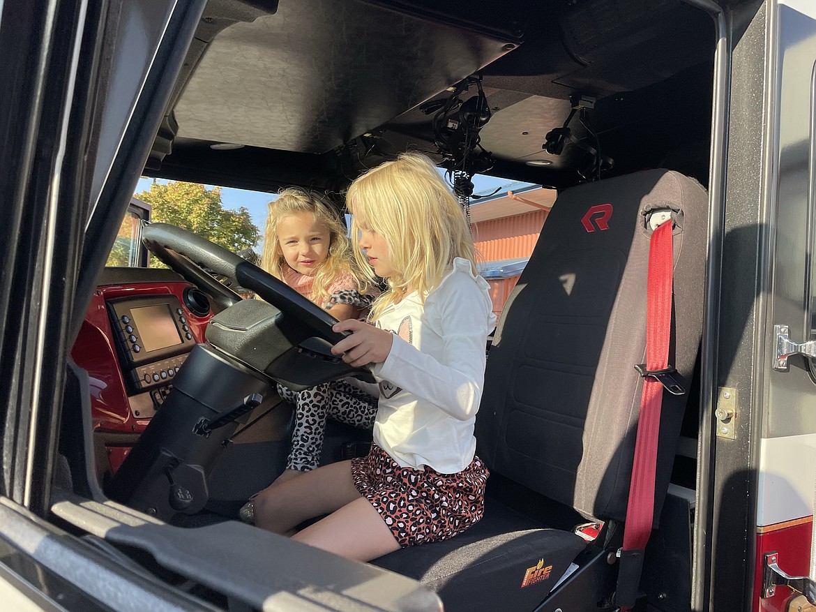 Mabel Hickok, 4, and her sister Sloane, 6, sit at the wheel of a Moses Lake Fire Department truck during the 2022 Pancake Breakfast, jointly sponsored by the Moses Lake Lions Club and Local 1258 of the International Association of Fire Fighters. It’s the first breakfast since 2019, and was canceled in 2020 and 2021 because of the COVID-19 pandemic.