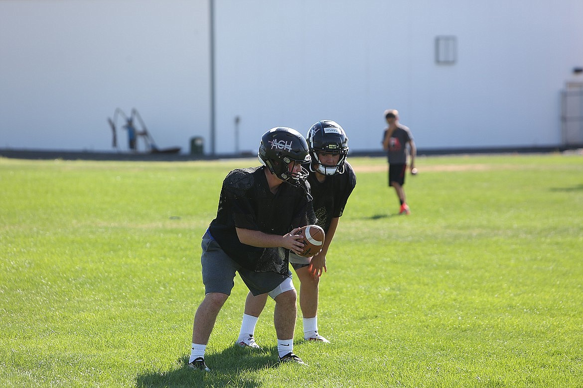 ACH quarterback Carter Pitts, left, rushed for 346 yards in the Warriors’ 60-58 win over Wilbur-Creston-Keller on Friday night.