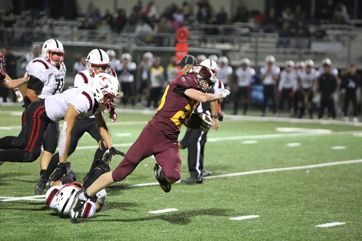 Moses Lake senior running back Maddox Gwinn powers through a tackle on a 15-yard run in the fourth quarter to seal the win.