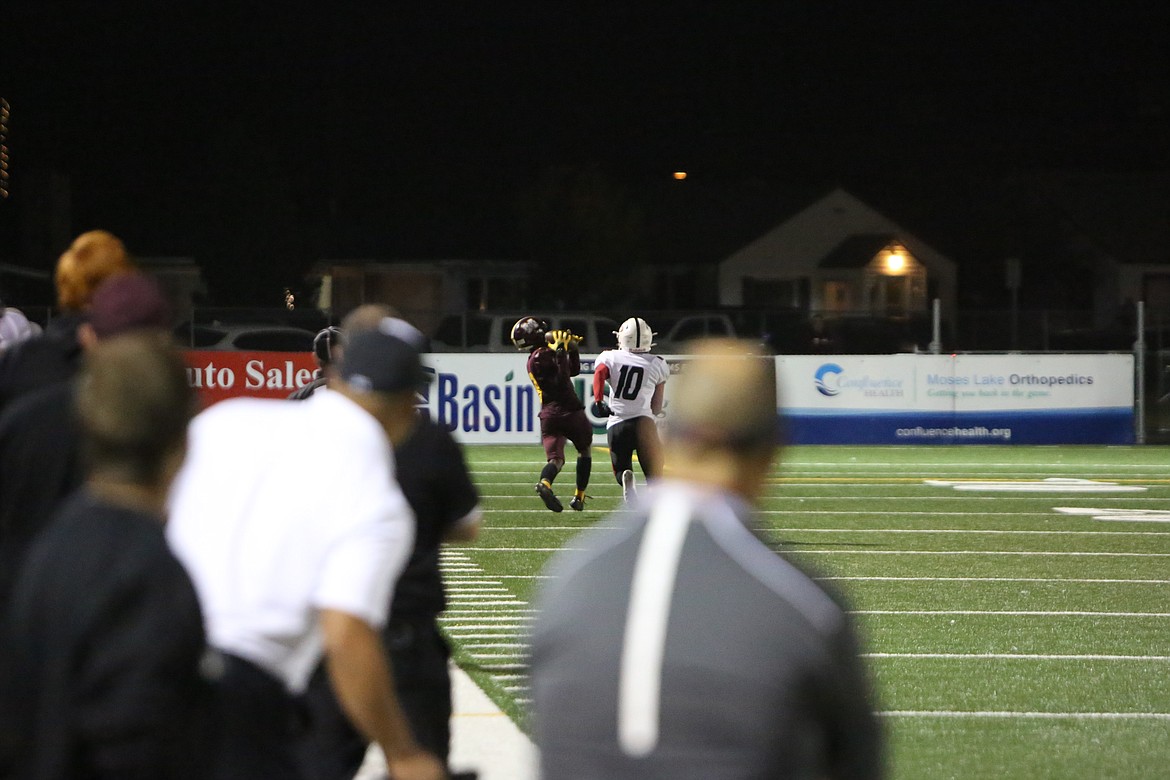 Moses Lake junior receiver hauls in a 51-yard touchdown pass along the sideline in the third quarter of Friday night’s win.