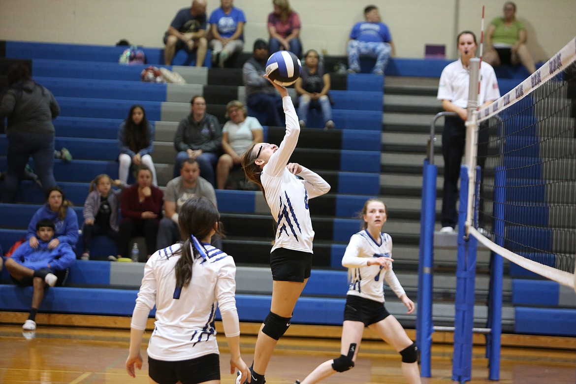 Soap Lake freshman Tanya Zubritiskiy taps the ball over the net in the third set to score on a volley.