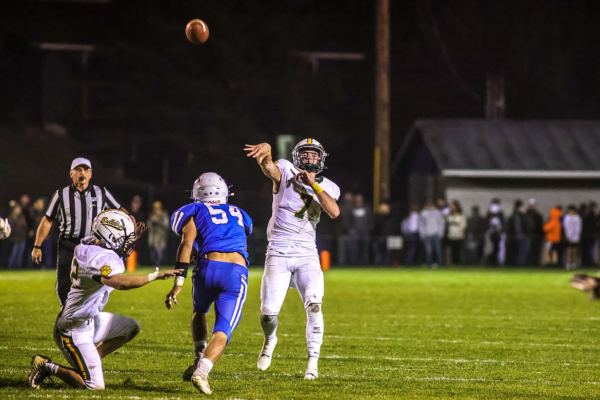 Senior quarterback Fynn Ridgeway makes a pass with incoming pressure in Columbia Falls on Oct. 14. (JP Edge/Hungry Horse News)