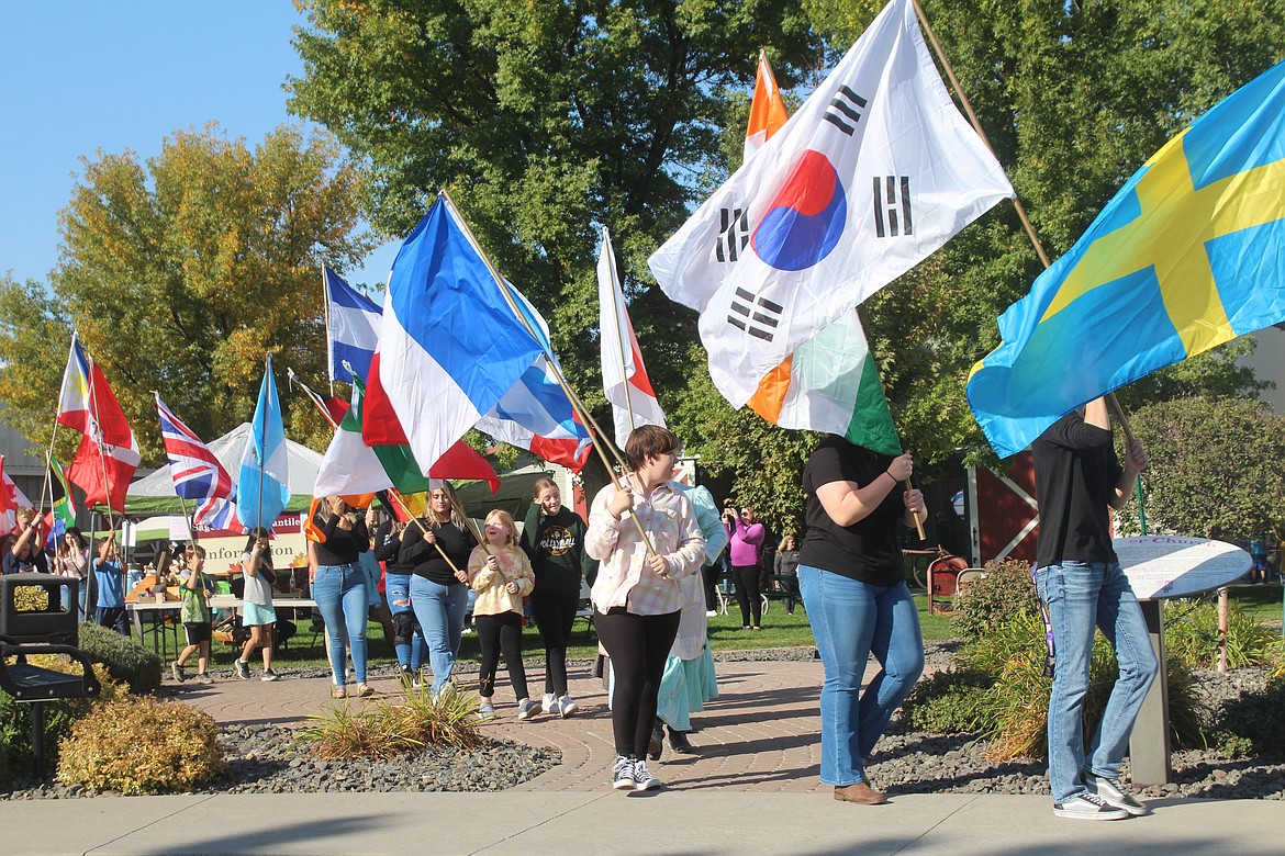Volunteers carry flags from the many nations of immigrants, past and present, that contributed to the Quincy Valley.