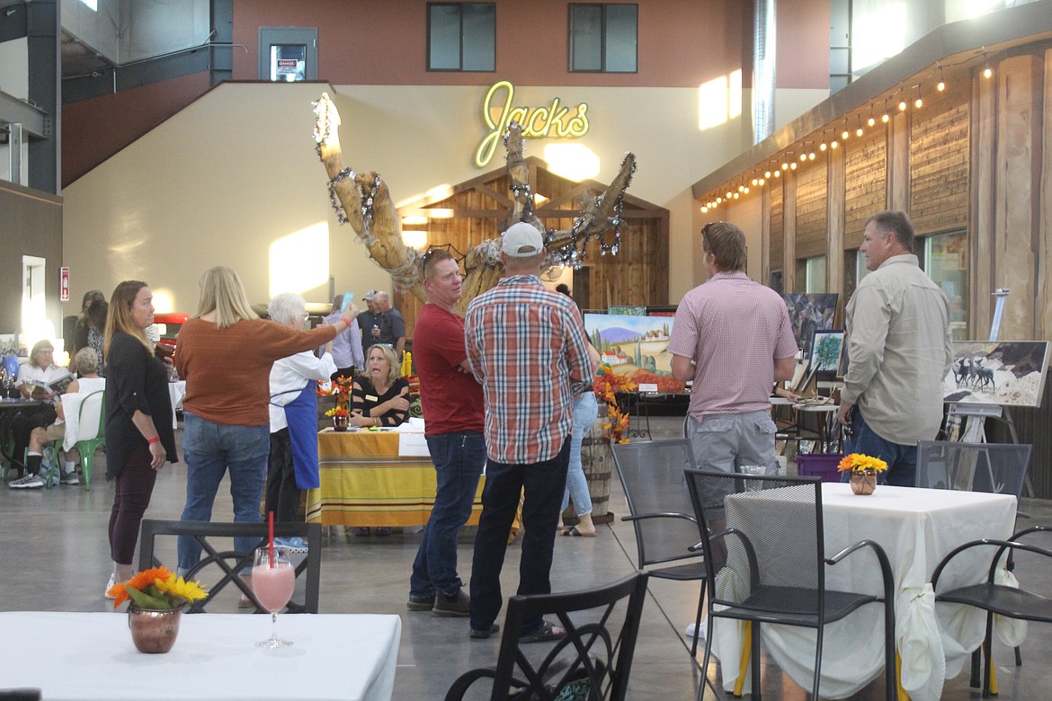 Conversation, art, music, wine and beer filled the Quincy Public Market Saturday during the “Art, Wine and Brews” event.