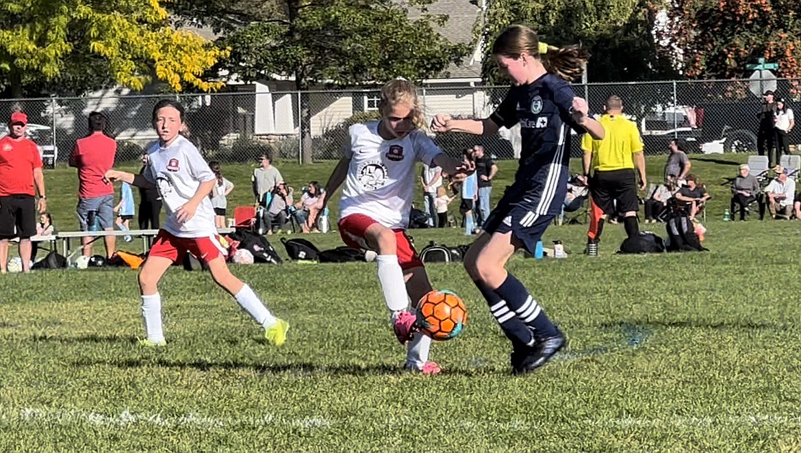 Photo by JULIE SPEELMAN
Parvati Palmgren of the Thorns U11 girls battles for a ball as teammate Avery Thompson, left, looks on. The Thorns, with one goal from Palmgren and two from Gracie McVey, beat the Spokane Sounders 3-2 on Saturday at the Canfield Sports Complex.