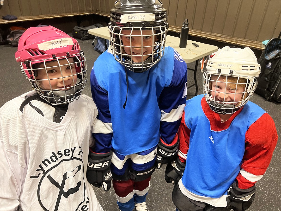 Sisters Zoey, Kassidy, and Marley Coleman are ready to take to the ice during the Fall Into Hockey program last month. (Photo provided)