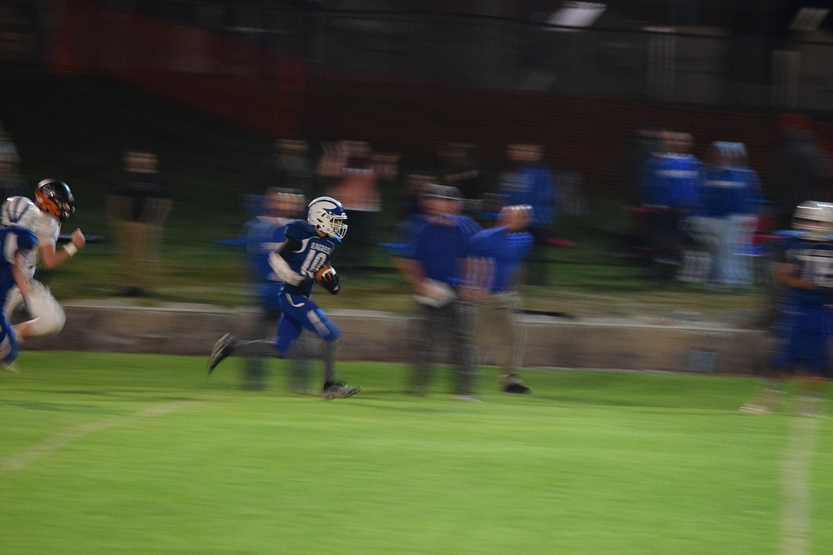 Soap Lake junior Alex Bustos carries the ball along the sideline during the Soap Lake homecoming game on Friday.