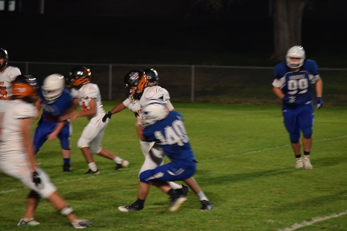 Soap Lake junior Kaleb Weaver tackles an Entiat player near the goal line during the Eagles’ homecoming game on Friday.