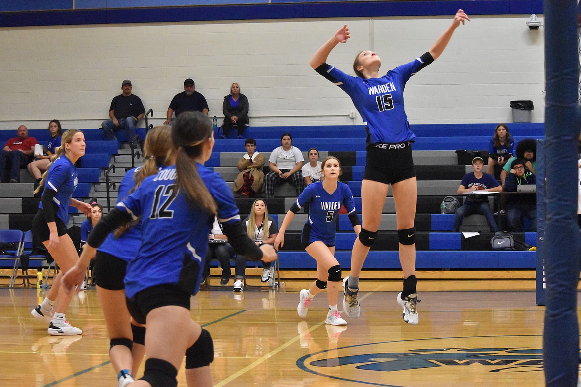 Warden sophomore Lauren Chamberlain (15) goes in for a spike as her teammates prepare for Walla Walla Valley Academy’s response.