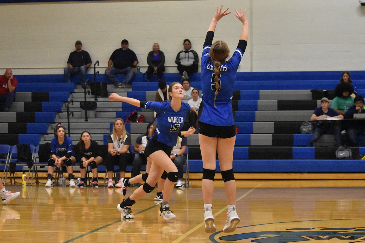 Warden sophomore Lauren Chamberlain (15) prepares to hit the ball as senior Brooke Gibbons (5) sets the ball for Chamberlain.