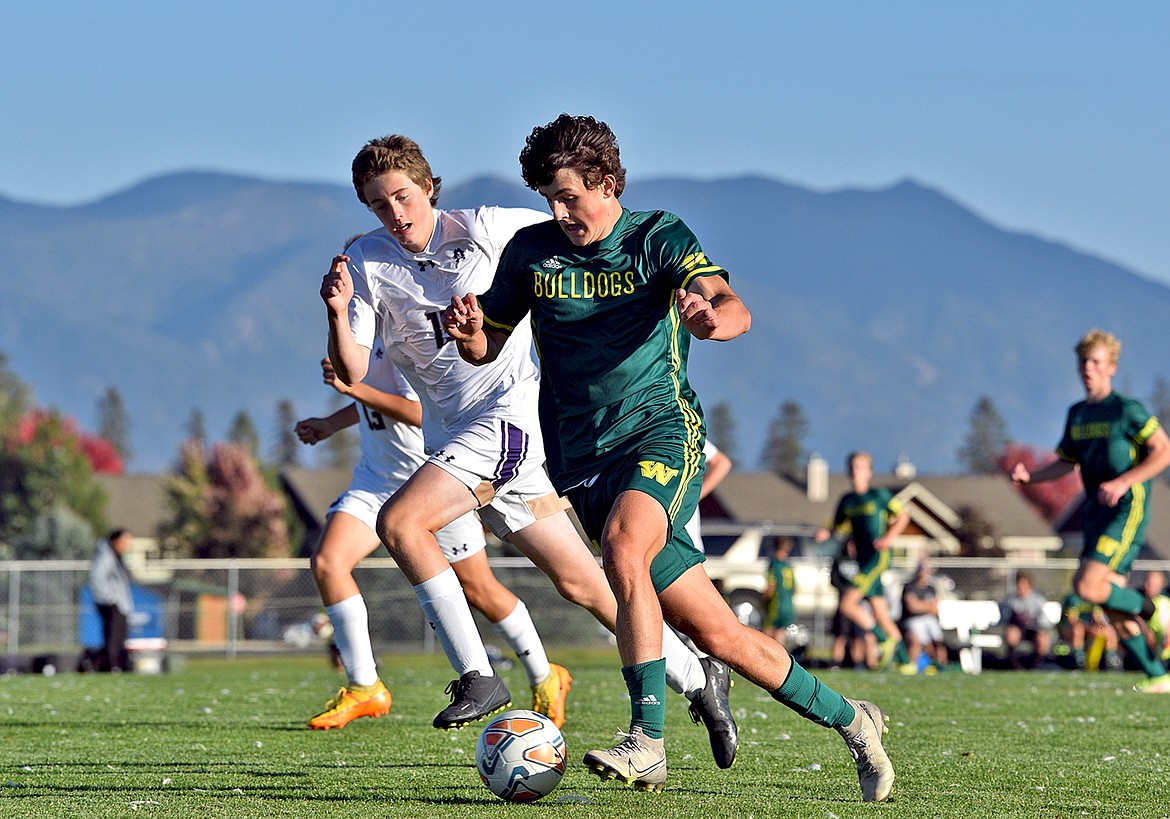 Bulldog Collin Lyman works the ball up the field in a postseason play-in game against Polson on Tuesday, Oct. 11 at Smith Fields. (Whitney England/Whitefish Pilot)