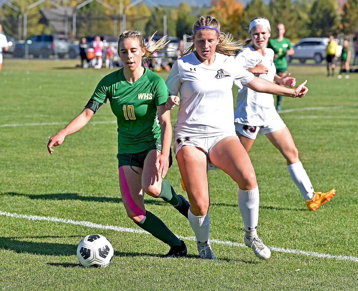 Whitefish senior Maddie Muhlfeld challenges a Laurel defender in the Class A quarterfinal playoff game on Saturday at Smith Fields. (Whitney England/Whitefish Pilot)