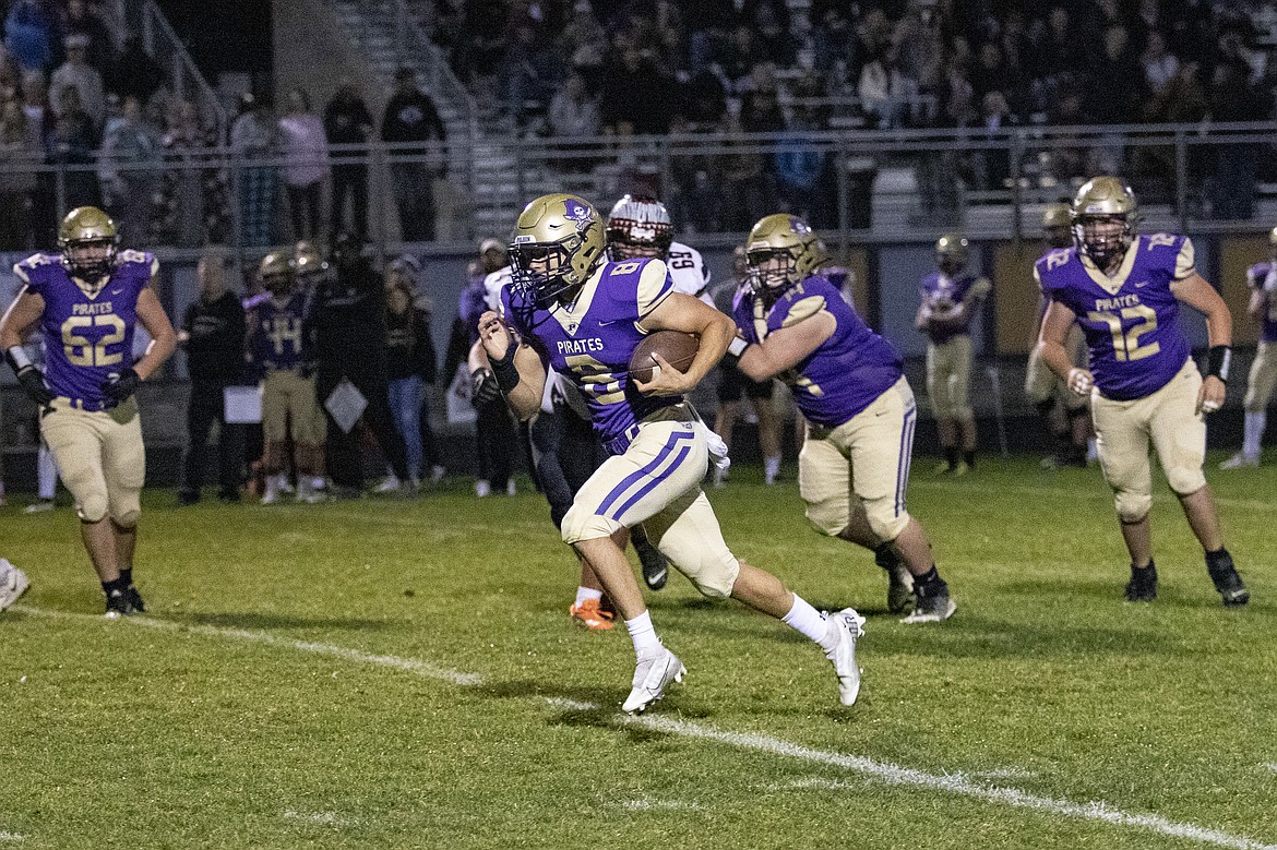 Polson Pirate quarter back Jarrett Wilson scrambles for a first down. (Rob Zolman/ Lake County Leader)