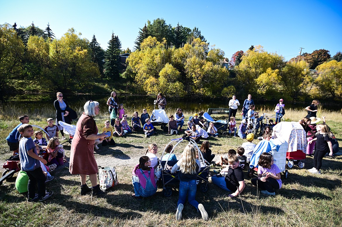 Hedges Elementary School third-grade teacher Melaina Ames, bottom left, speaks to students as they circle their wagons and take a break during a lesson on the Oregon Trail at Dry Bridge Park in Kalispell on Tuesday, Oct. 18. (Casey Kreider/Daily Inter Lake)