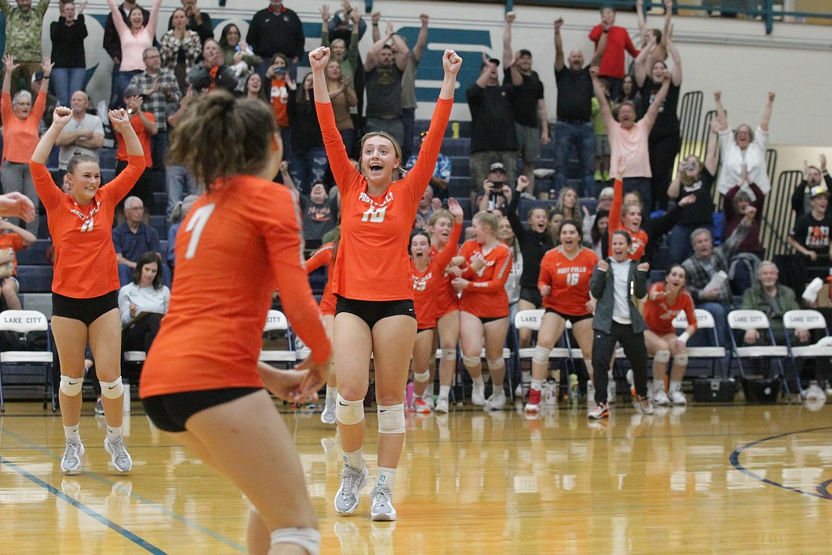 MARK NELKE/Press
Kylie Munday (10) celebrates, along with teammates Shauna Cozza (11) and Trinity Byrne, and the rest of the Post Falls faithful after the Trojans beat the Lake City Timberwolves to win the 5A Region 1 volleyball championship Tuesday night at Lake City High.