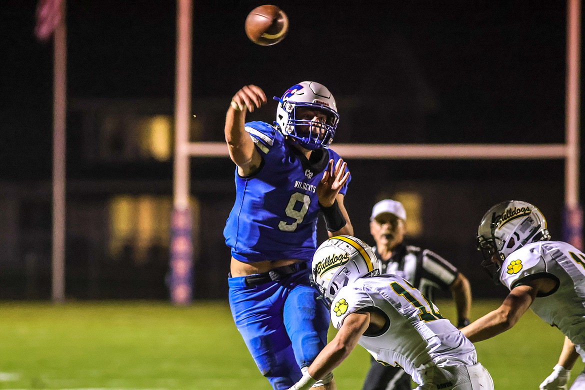 Junior Wildcats quarterback Cody Scweikert throws under pressure from the Bulldogs in Columbia Falls on Oct. 14. (JP Edge photo)