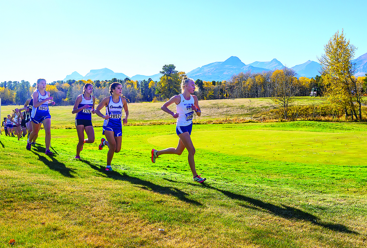 From left, Mya Badger, Marissa Schaeffer and Ally Sempf run the course at the Western A divisional meet in East Glacier on Saturday. (Chris Peterson photo)