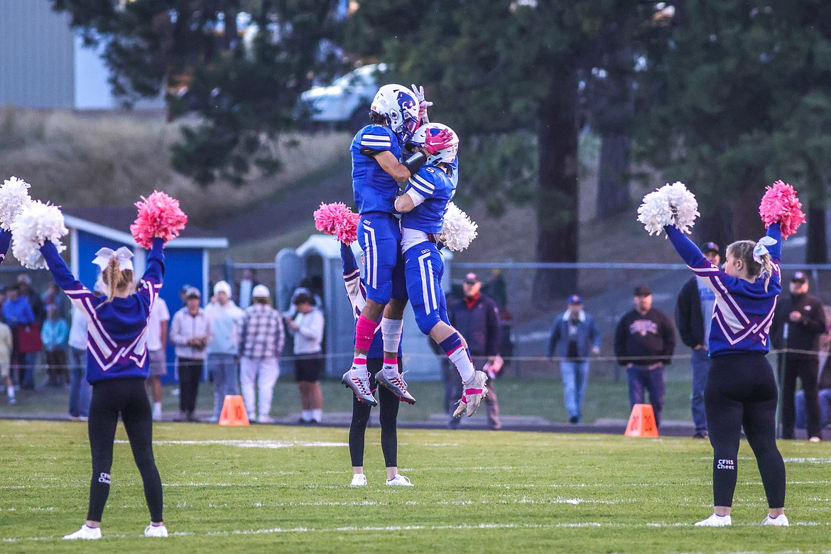 Jace Duval and Mark Robison embrace before their game against Whitefish. (JP Edge photo)