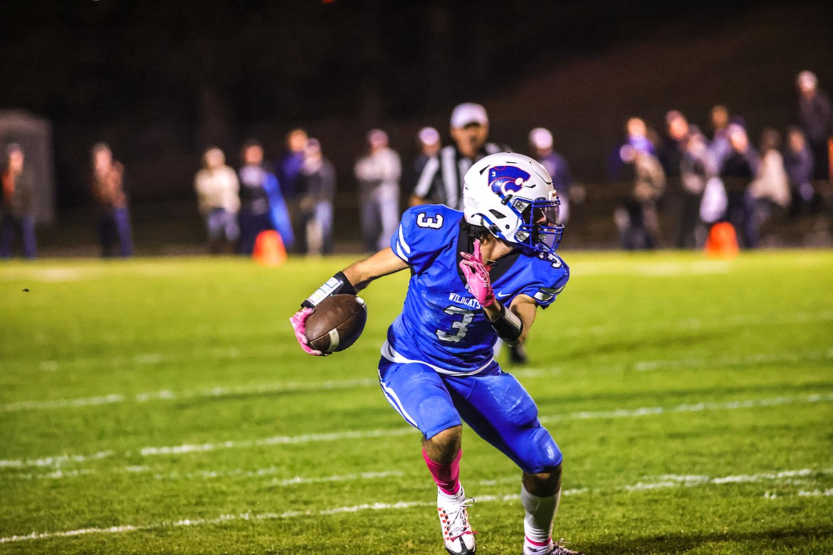 Senior Jace Duval completes a pass from Cody Schweikert to gain a first down for the Wildcats against Whitefish in Columbia Falls on Oct. 14. (JP Edge photo)