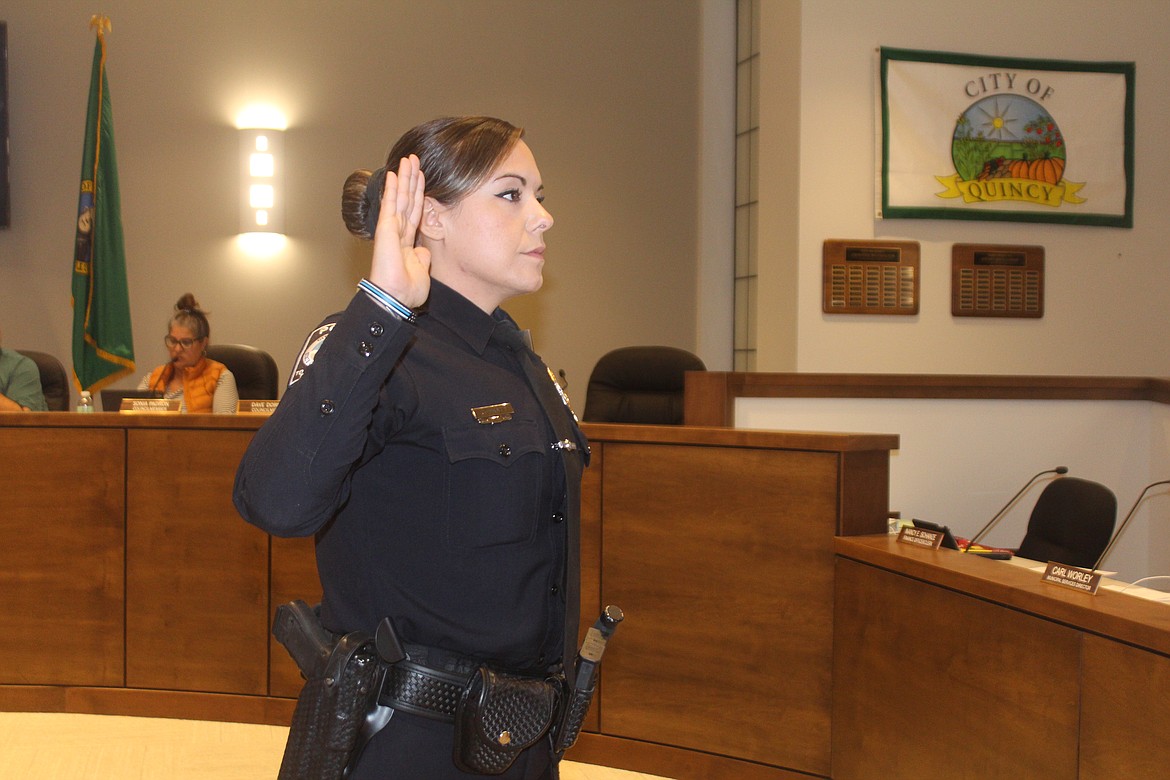 Emily Pratt takes the Quincy Police Department oath of office during Tuesday’s Quincy City Council meeting. Pratt said she's excited to start the new position and that community service has been a long-time goal of hers.