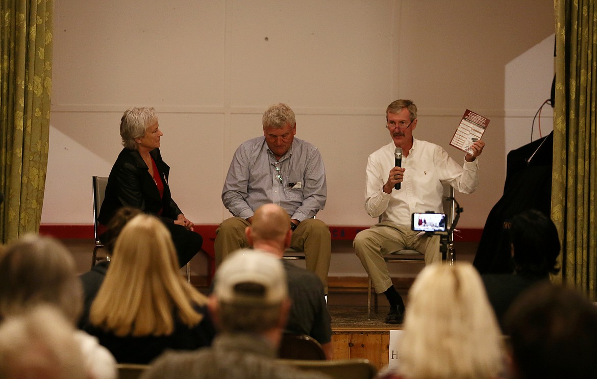 Ronald Hartman, right, states that he, Diana Sheridan, left, and Mike Waggoner are recommended by the local Republican party Thursday evening during the North Idaho College trustee candidate forum at the Mica Flats Grange Hall.