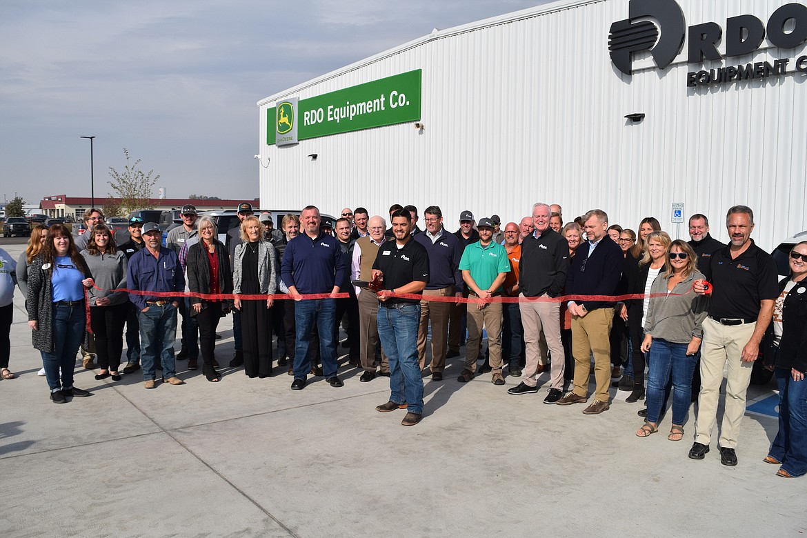 RDO Equipment’s Moses Lake store manager Jacob Garza, surrounded by RDO executives, employees, and members of the Moses Lake Chamber of Commerce, cuts the ribbon on Thursday to formally celebrate the grand opening of the company’s new Moses Lake store at 12378 N Frontage Rd. E.