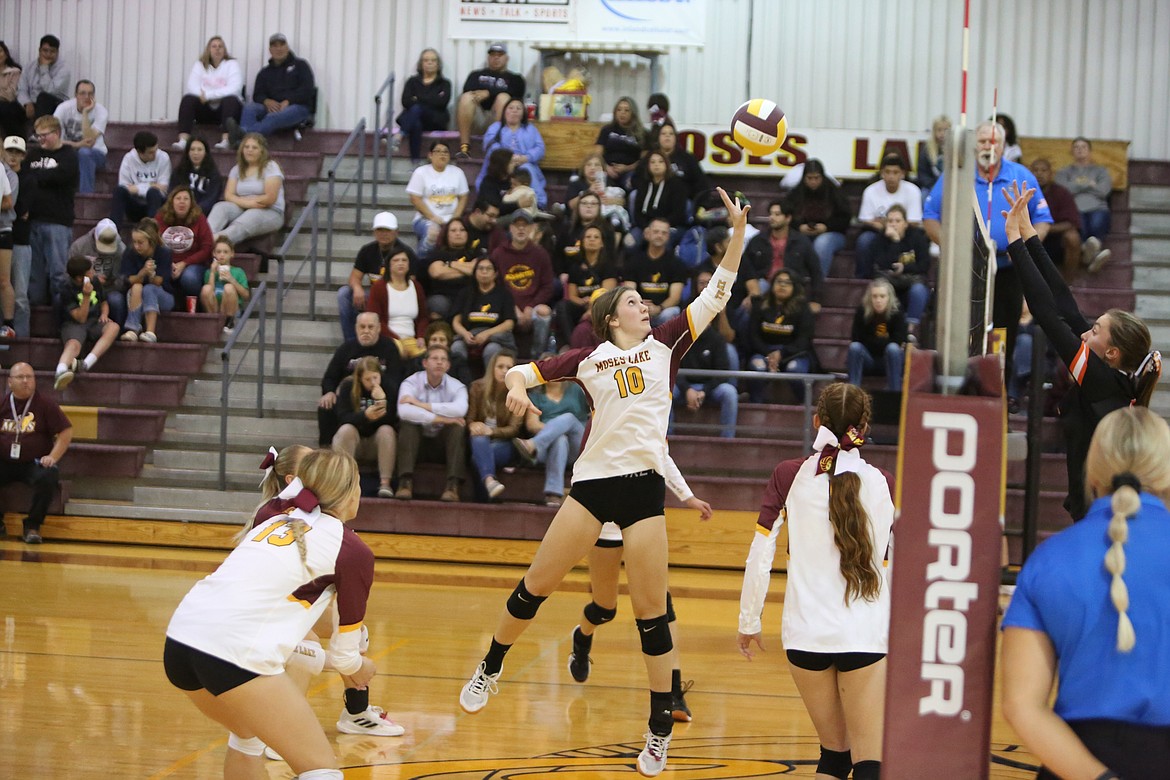 Maverick sophomore Kenna Stuart tips the ball over the net during the fourth set of Moses Lake’s matchup against Davis on Thursday.