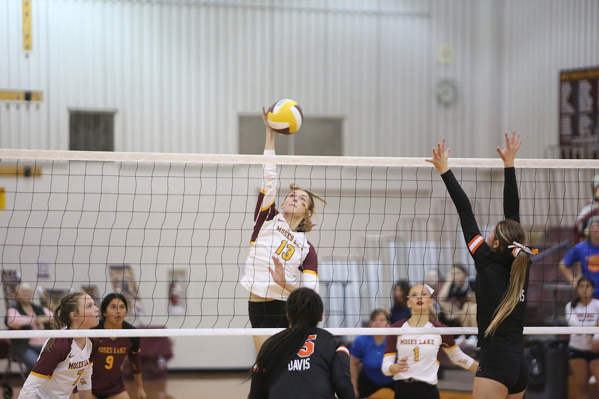 Moses Lake senior Kathryn Pugh spikes the ball over the net for a kill in the second set.