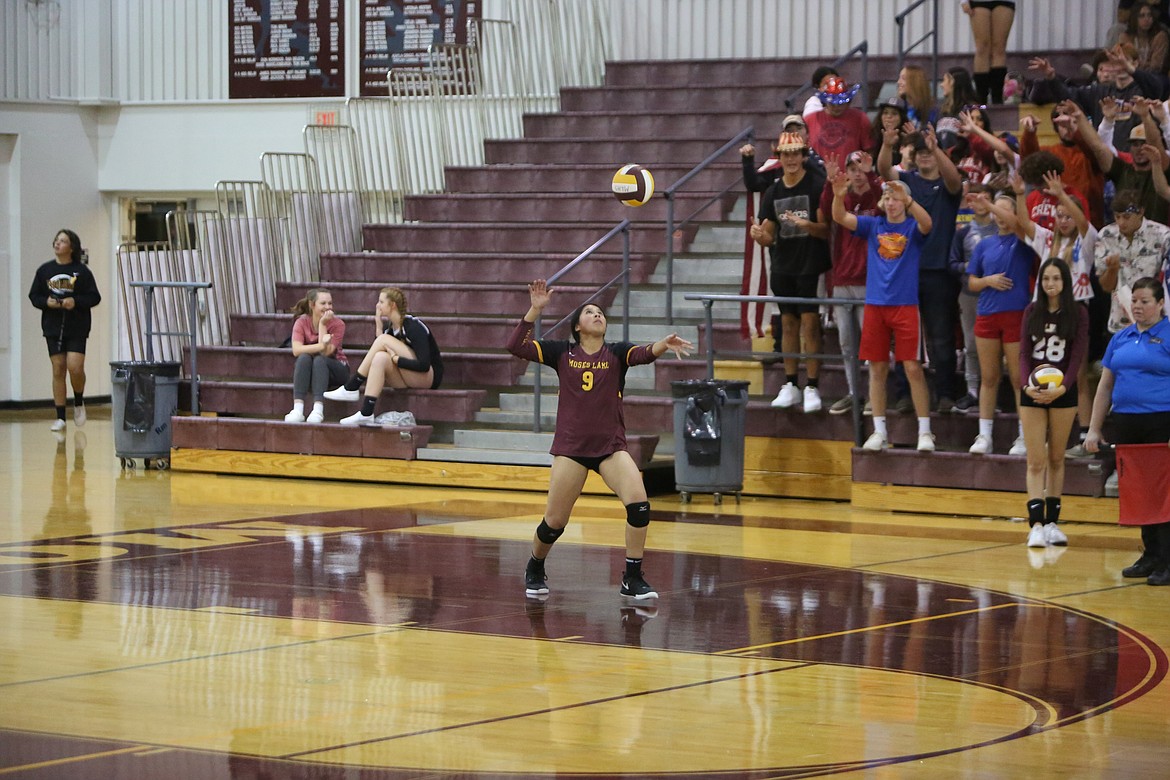 In front of the Moses Lake student section, senior Jazlynn Torres serves the ball for the Mavericks.