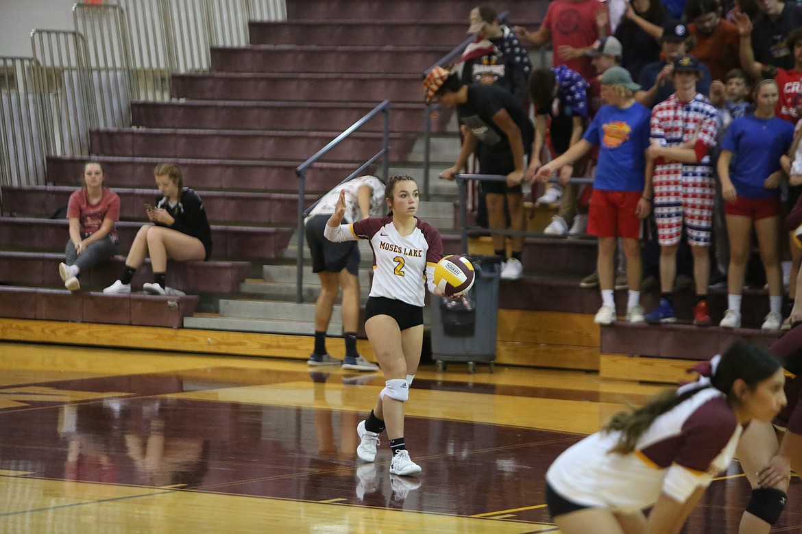 Moses Lake junior Raegen Hofheins looks on before serving the ball in the fourth set,