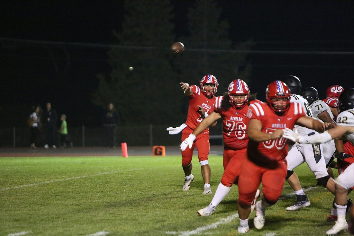 Othello quarterback Maddox Martinez (7) throws a quick pass to his right as offensive lineman pull to block.