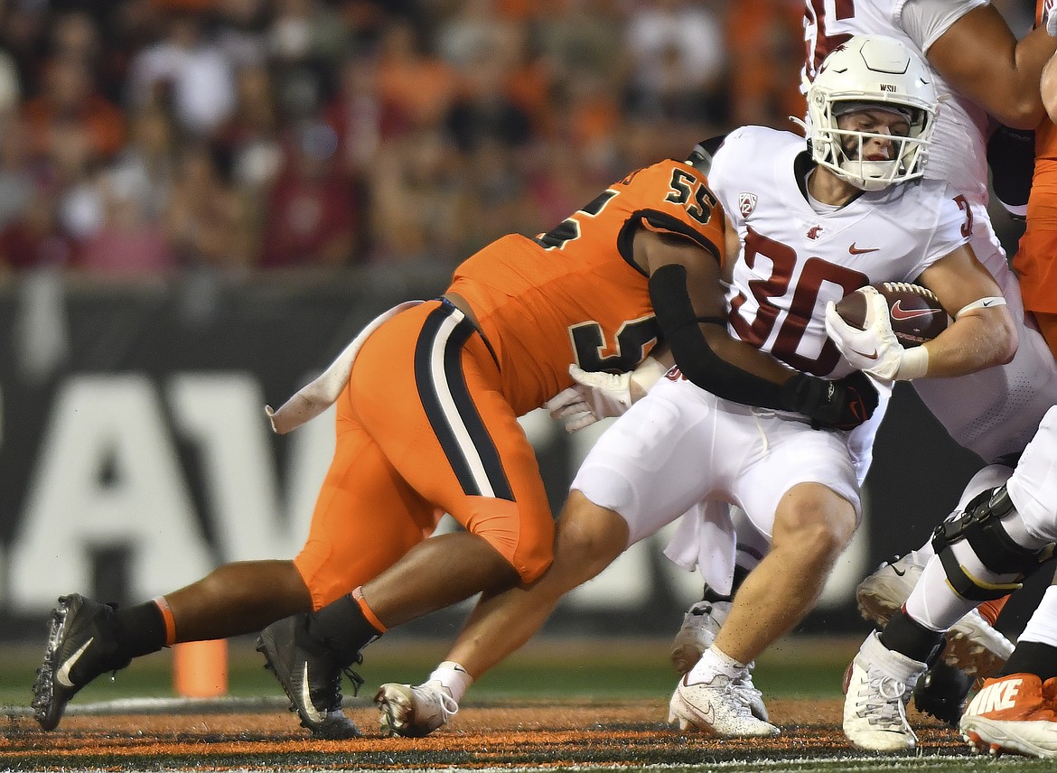 Washington State running back Dylan Paine gets tackled by an Oregon State defender during the Cougs’ 24-10 loss on Saturday. WSU rushed for 23 total yards on Saturday, a season-low.