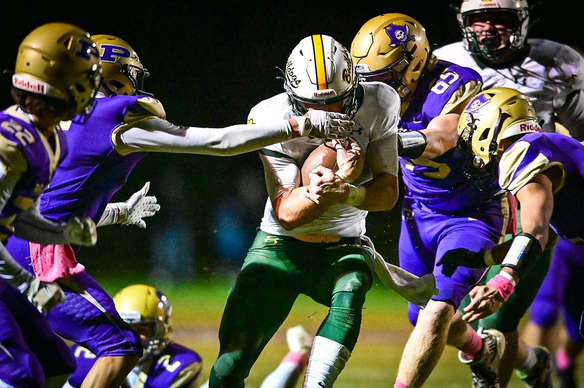 Whitefish quarterback Fynn Ridgeway (7) is swarmed by Polson defenders on a run in the second quarter against Polson at Polson High School on Friday, Oct. 21. (Casey Kreider/Daily Inter Lake)