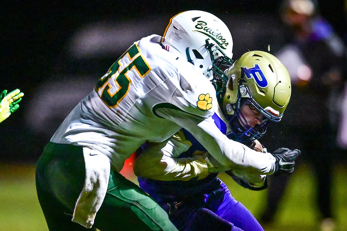 Polson running back Keyen Nash (33) is tackled by Whitefish defensive lineman Kai Nash (55) in the second quarter at Polson High School on Friday, Oct. 21. (Casey Kreider/Daily Inter Lake)