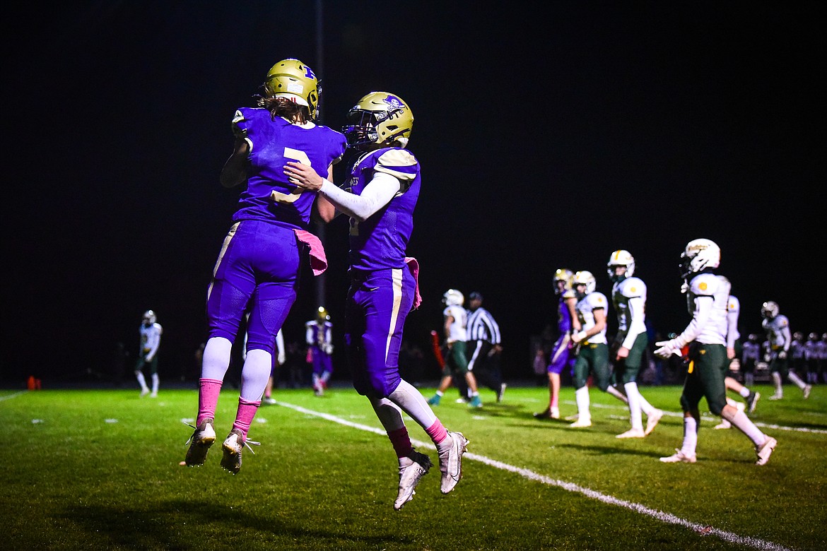 Polson quarterback Jarrett Wilson (8) celebrates with wide receiver Tommy Sherry (3) after a touchdown in the second quarter against Whitefish at Polson High School on Friday, Oct. 21. (Casey Kreider/Daily Inter Lake)