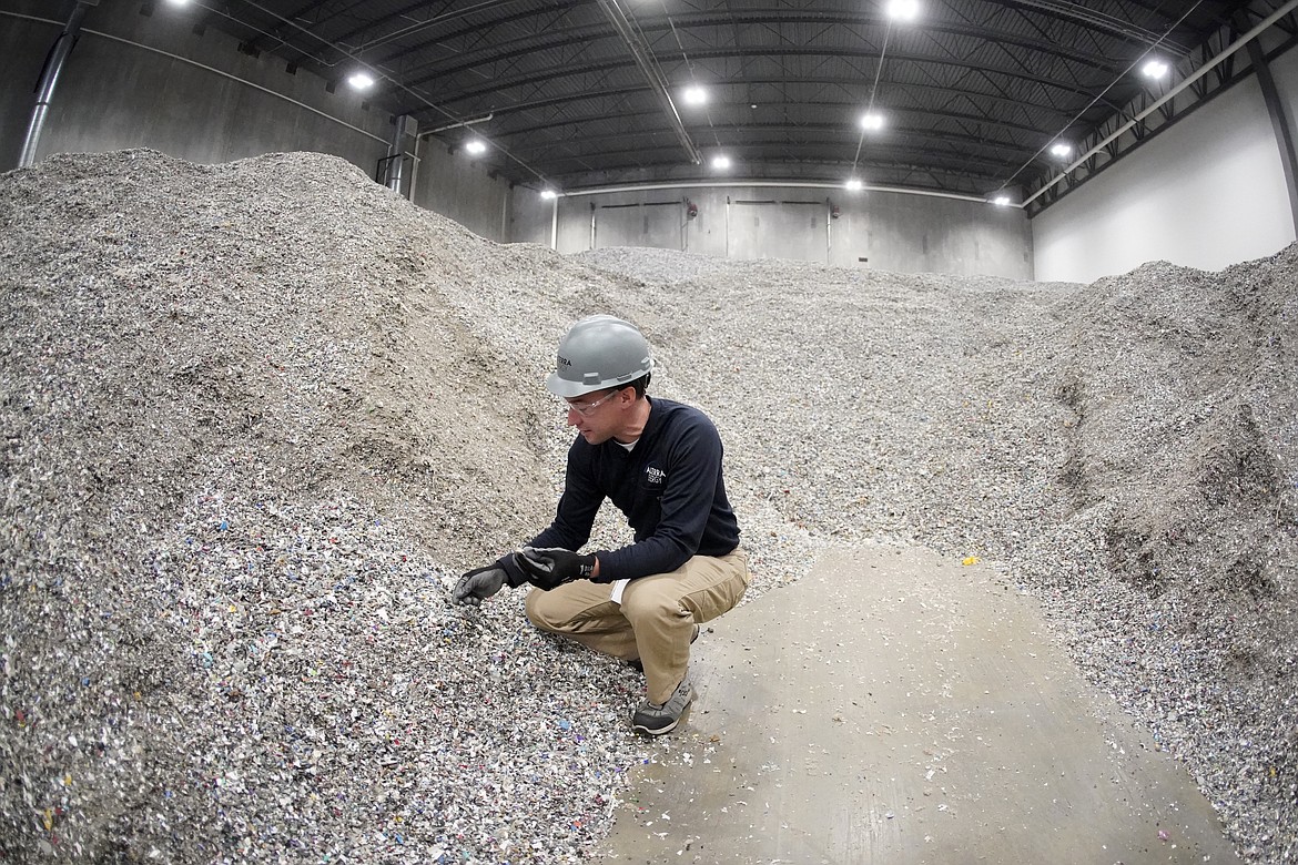 Jeremy DeBenedictis, President of Alterra Energy, stands in the storage area of shredded plastics his company receives from recycling facilities in their facility in Akron, Ohio, on Thursday, Sept. 8, 2022. “Our mission is to solve plastic pollution,” said DeBenedictis, company president. “That is not just a tag line. We all truly want to solve plastic pollution.” (AP Photo/Keith Srakocic)