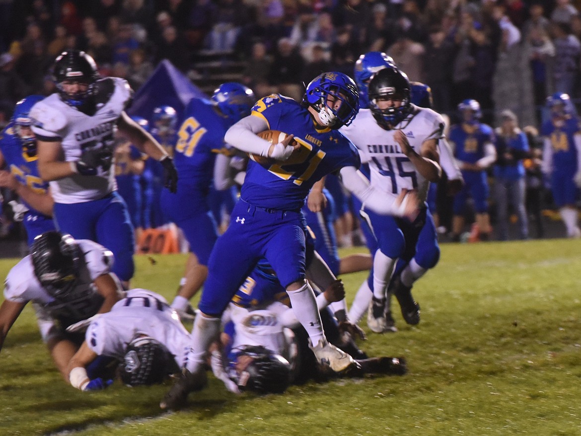 Libby's Trent Riddel steps out of an attempted tackle in Friday's game against Corvallis. The Loggers won 52-42. (Scott Shindledecker/The Western News)