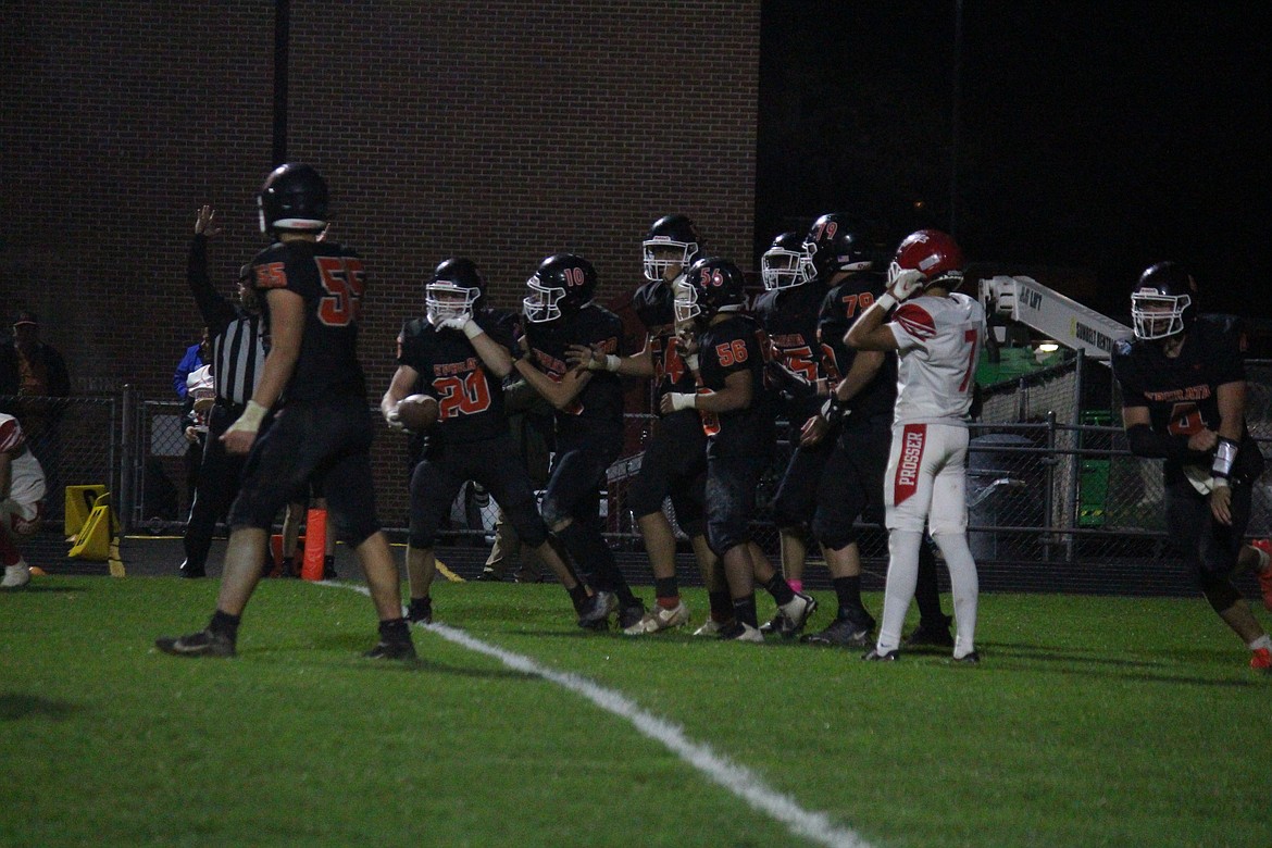 Teammates congratulate Hudson Sager (20) on his game-winning touchdown. Ephrata defeated Prosser 20-17.