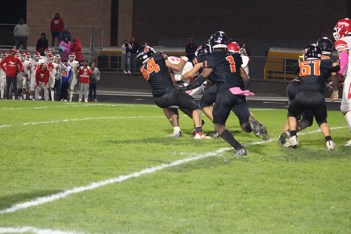 Led by Vaden Dormaier (54), the Ephrata defense swarms a Prosser runner.