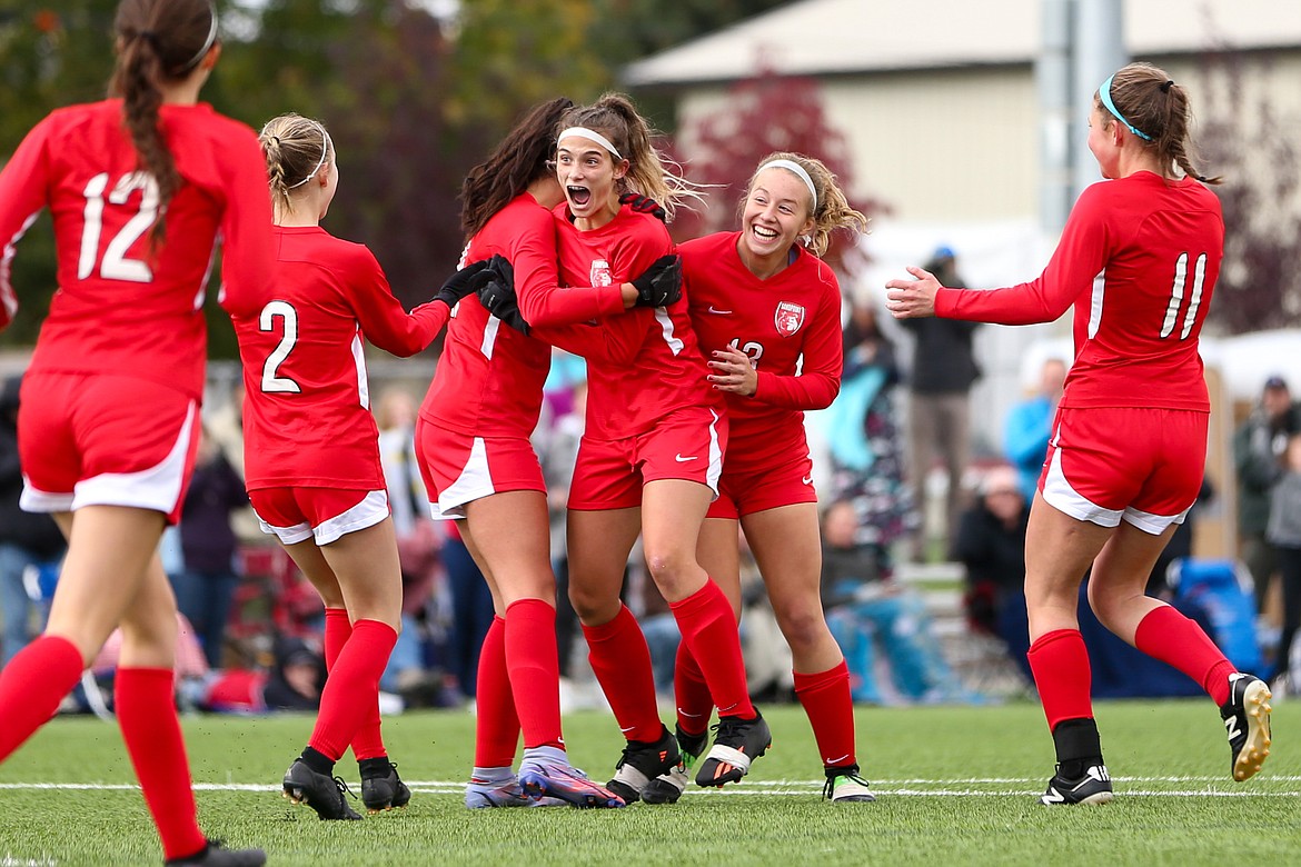 Marlee McCrum (2), Hannah Harvey (21), Aliya Strock (16), Addie Guidos (13) and Riley Medeiros (11) celebrate a goal in Saturday consolation championship at the Idaho 4A State Soccer Tournament.